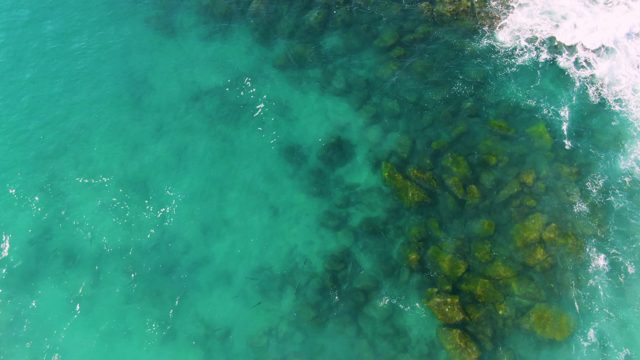 BUZZARDS EAST CAPE LOS CABOS BCS MEXICO-2022: Clear Turquoise Ocean Water with Underwater Rocks and Gentle Waves
