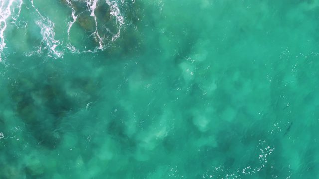 BUZZARDS EAST CAPE LOS CABOS BCS MEXICO-2022: Turquoise Ocean Waves Breaking Over Rocky Seabed