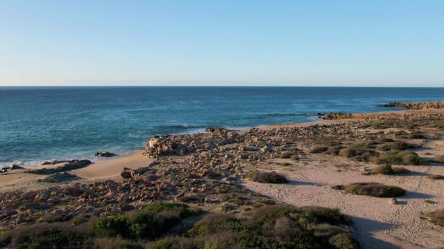 BUZZARDS EAST CAPE LOS CABOS BCS MEXICO-2022: Ocean Waves Lapping Rocky Shore