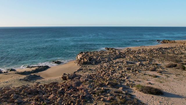 BUZZARDS EAST CAPE LOS CABOS BCS MEXICO-2022: Gentle Ocean Waves on Rocky Shoreline