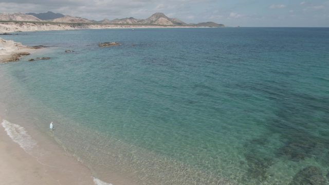 PLAYA EL ARBOLITO CABO PULMO BCS MEXICO-2022: Sandy Beach with Clear Turquoise Water and Distant Mountains