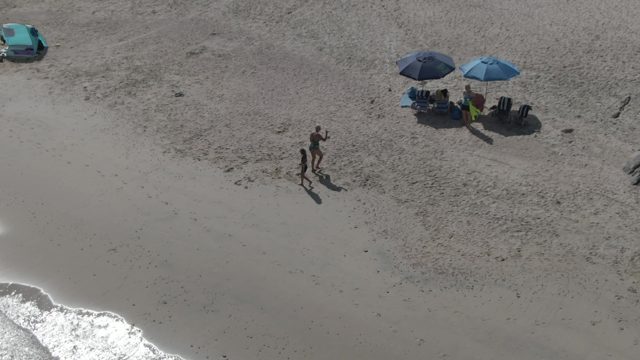 PLAYA EL ARBOLITO CABO PULMO BCS MEXICO-2022: Couple Strolling on Sandy Beach From Above