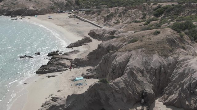 PLAYA EL ARBOLITO CABO PULMO BCS MEXICO-2022: Coastal Beach with People Walking near Rocky Cliffs