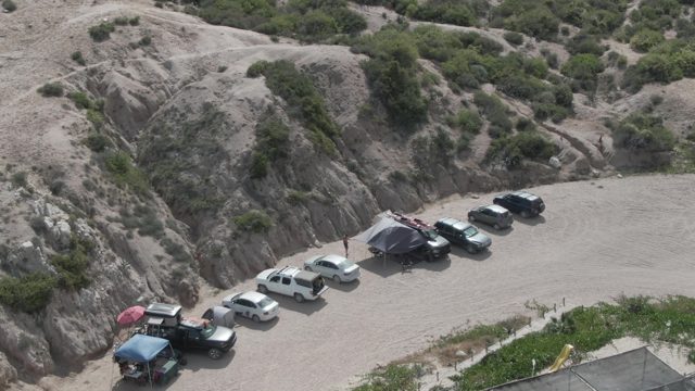 PLAYA EL ARBOLITO CABO PULMO BCS MEXICO-2022: Desert Parking Area with Rocky Hills and Vehicles