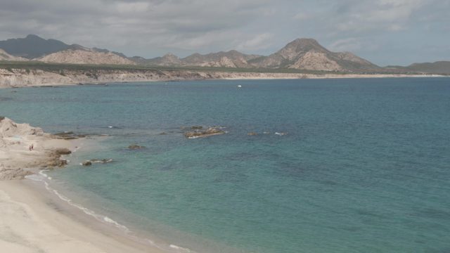 PLAYA EL ARBOLITO CABO PULMO BCS MEXICO-2022: Beach with Clear Blue Water and Mountainous Coastline