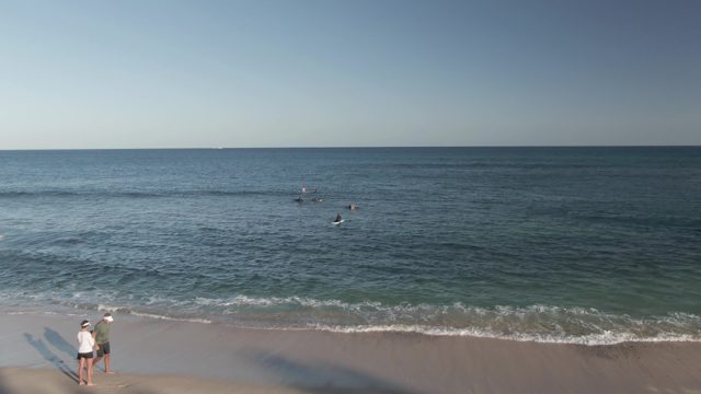 COSTA AZUL LOS CABOS BCS MEXICO-2022: Beachgoers Swimming and Walking Along Sandy Shore