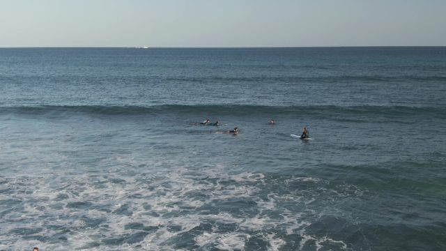 COSTA AZUL LOS CABOS BCS MEXICO-2022: Surfer Rides Wave While Others Wait in Ocean