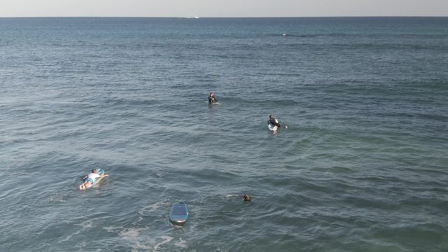 COSTA AZUL LOS CABOS BCS MEXICO-2022: Surfers Paddling in Ocean Waves