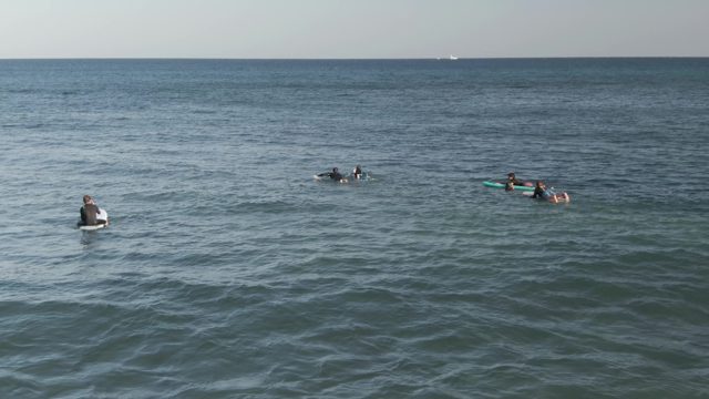 COSTA AZUL LOS CABOS BCS MEXICO-2022: Surfers Paddling in Calm Ocean Waters