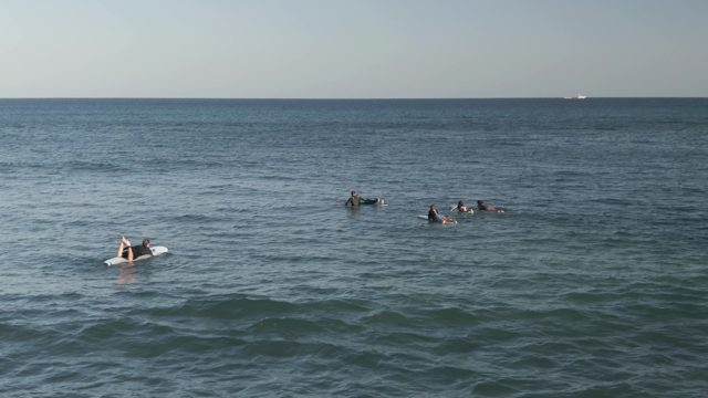 COSTA AZUL LOS CABOS BCS MEXICO-2022: Surfers Paddling in Calm Ocean Waters