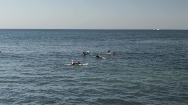 COSTA AZUL LOS CABOS BCS MEXICO-2022: Surfers Paddling in Calm Ocean Water