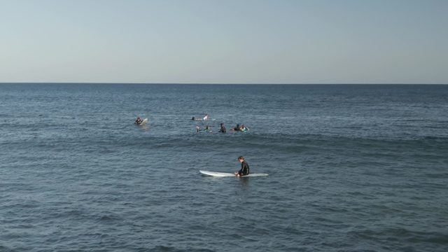 COSTA AZUL LOS CABOS BCS MEXICO-2022: Surfers Paddling in Calm Ocean Waters