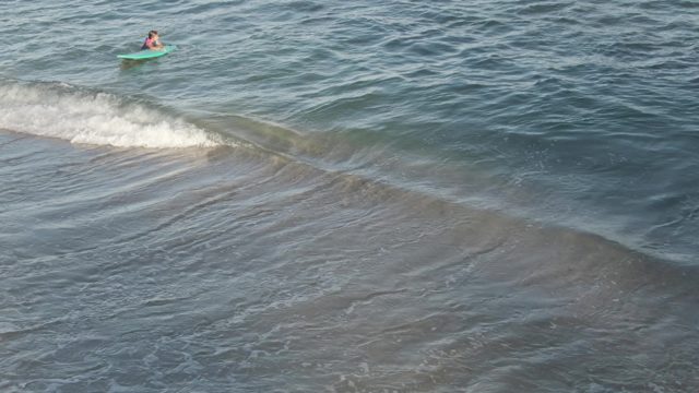 COSTA AZUL LOS CABOS BCS MEXICO-2022: Bodyboarder Floating in Shallow Ocean Waves