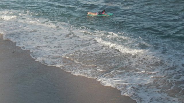 COSTA AZUL LOS CABOS BCS MEXICO-2022: Person on Bodyboard Riding Ocean Waves Toward Shore
