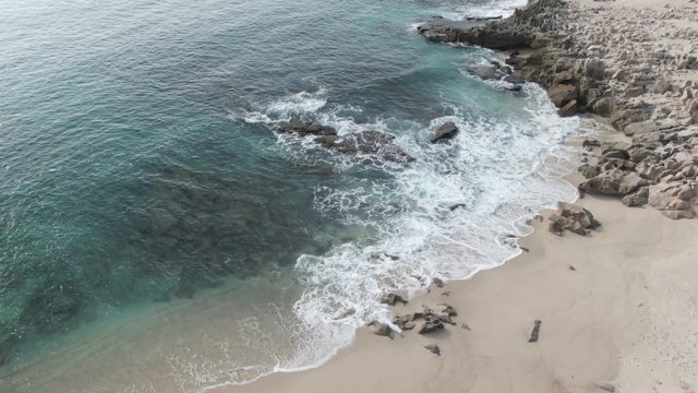 BUZZARDS EAST CAPE LOS CABOS BCS MEXICO-2022: Waves Crashing on Rocky Shore and Sandy Beach