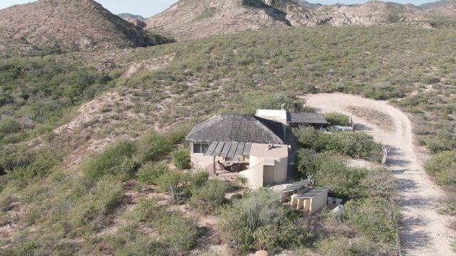 CABO PULMO BCS MEXICO-2022: Desert Hut and Winding Dirt Road in Arid Landscape