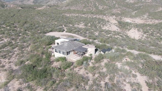 CABO PULMO BCS MEXICO-2022: Desert Home Surrounded by Sparse Vegetation and Hills