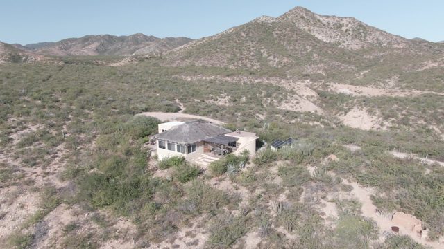 CABO PULMO BCS MEXICO-2022: Desert House with Sparse Vegetation and Distant Hills