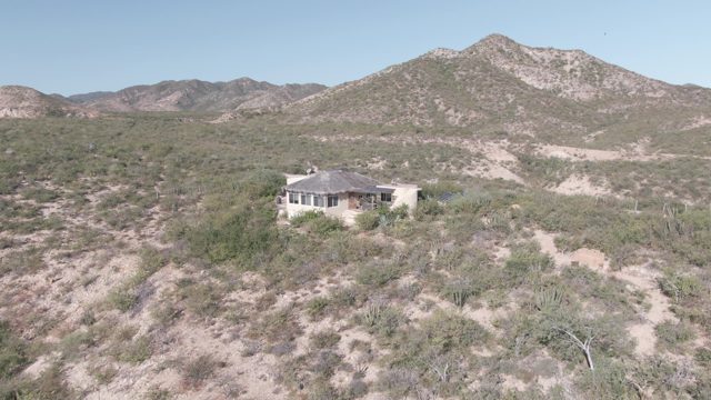 CABO PULMO BCS MEXICO-2022: Desert House Amidst Arid Vegetation and Distant Mountains