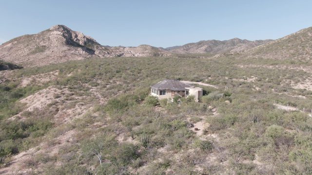 CABO PULMO BCS MEXICO-2022: Person Walking near Desert House on Hillside