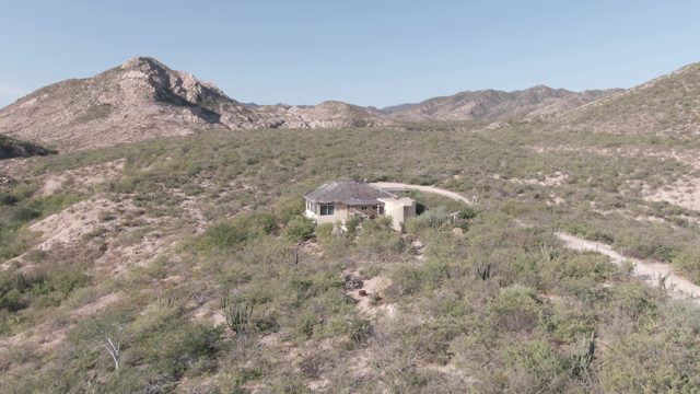 CABO PULMO BCS MEXICO-2022: Person Walking on Desert Path near House