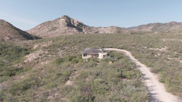 CABO PULMO BCS MEXICO-2022: Desert Landscape with Small Building and Winding Dirt Road