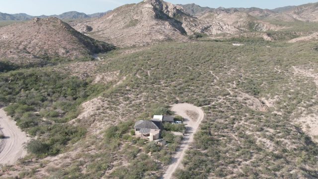 CABO PULMO BCS MEXICO-2022: Aerial Pan of Desert Structures and Winding Road