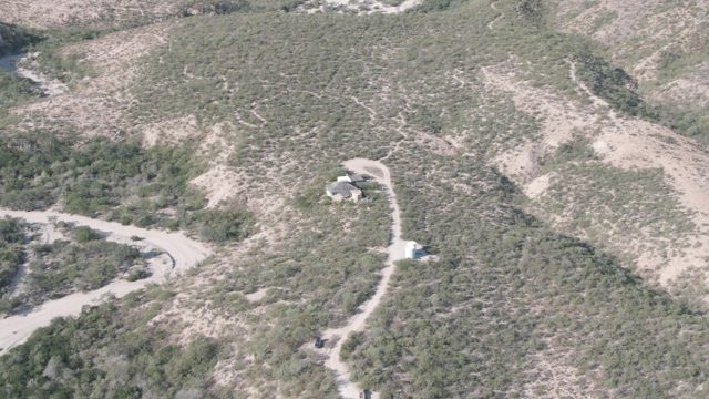 CABO PULMO BCS MEXICO-2022: Aerial Approach to Arid Hillside with Structures and Roads