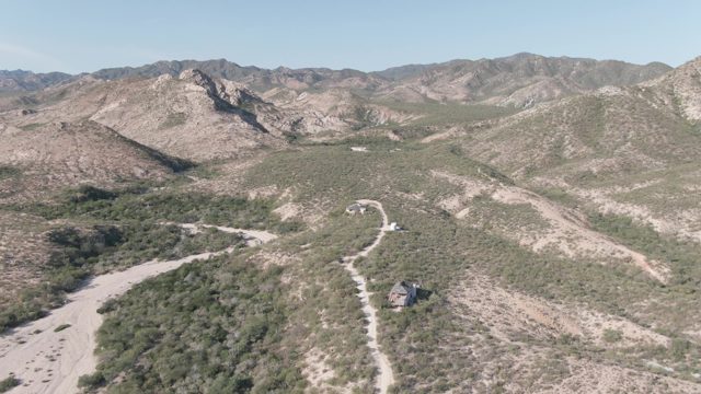 CABO PULMO BCS MEXICO-2022: Winding Mountain Road and Isolated House in Arid Terrain