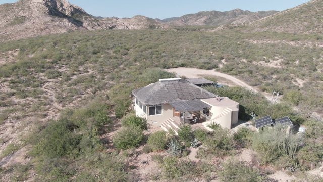 CABO PULMO BCS MEXICO-2022: A House in a Desert Landscape with Mountain Backdrop