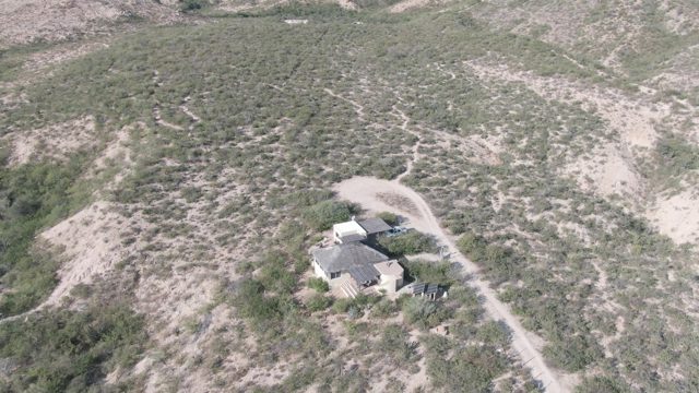 CABO PULMO BCS MEXICO-2022: Desert House with Sparse Vegetation and Sandy Terrain