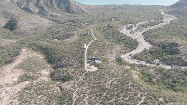 CABO PULMO BCS MEXICO-2022: Arid Hillside with Winding Dirt Paths and Structures