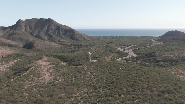 CABO PULMO BCS MEXICO-2022: Vehicle Traveling on Winding Dirt Road Through Hills