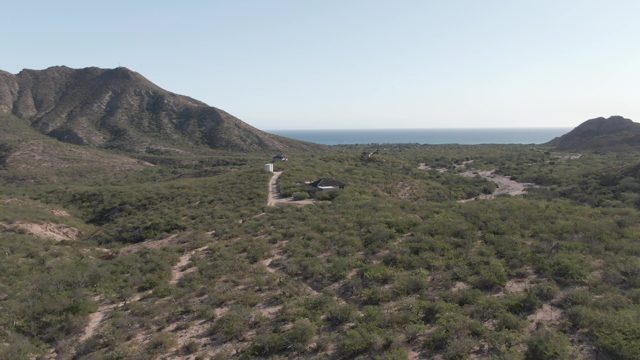 CABO PULMO BCS MEXICO-2022: Coastal Mountain Road with Sparse Vegetation and Ocean