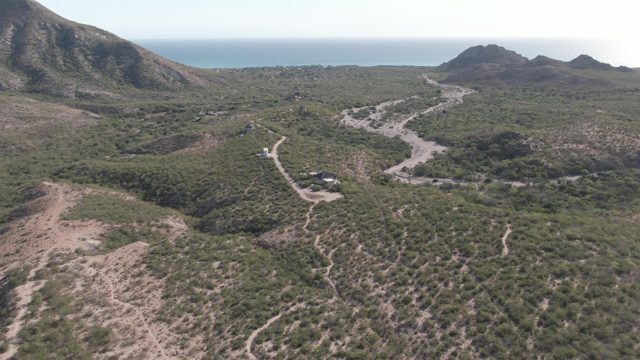 CABO PULMO BCS MEXICO-2022: Car Moving Along Winding Hillside Path