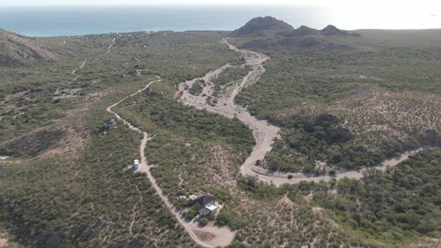CABO PULMO BCS MEXICO-2022: Vehicle Moving on Winding Dirt Road in Hilly Area