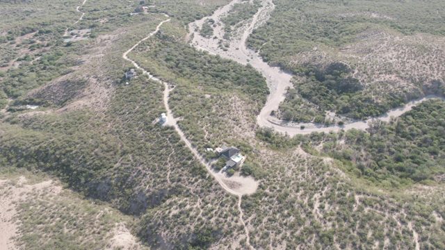 CABO PULMO BCS MEXICO-2022: Vehicle Moving on Winding Dirt Road Through Hilly Terrain