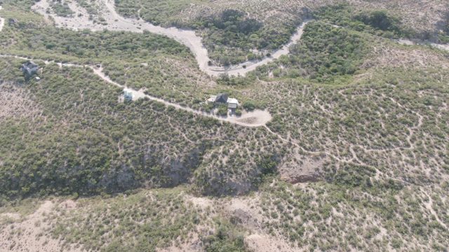 CABO PULMO BCS MEXICO-2022: Vehicles Moving on Winding Dirt Road Through Hilly Terrain