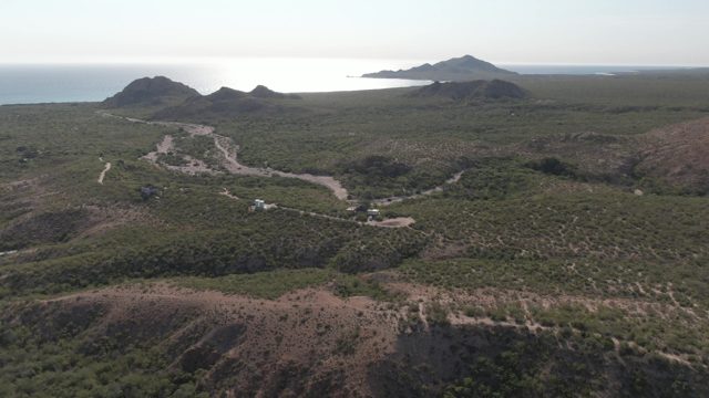CABO PULMO BCS MEXICO-2022: Vehicles Traveling on Winding Dirt Road Through Hilly Terrain