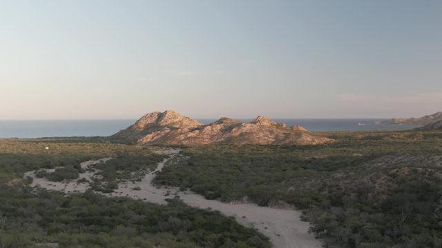 CABO PULMO BCS MEXICO-2022: Vehicle Moving Along Winding Coastal Dirt Path
