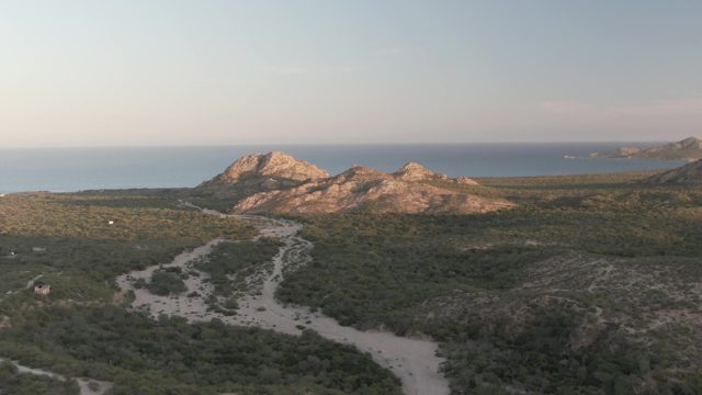 CABO PULMO BCS MEXICO-2022: Vehicle Travels on Winding Coastal Hillside Path