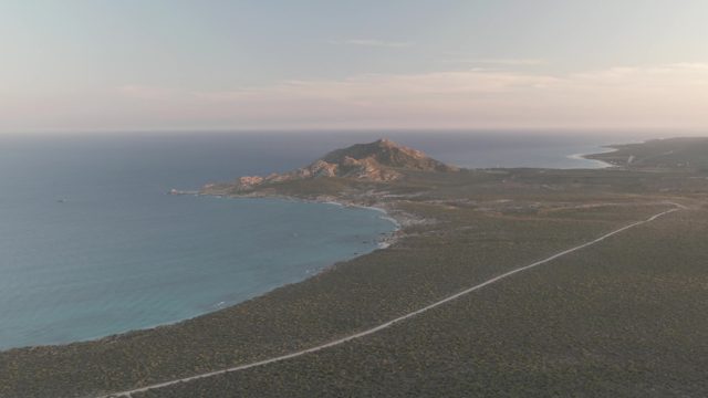 CABO PULMO BCS MEXICO-2022: Vehicle Traveling Along Coastal Road with Shifting Clouds