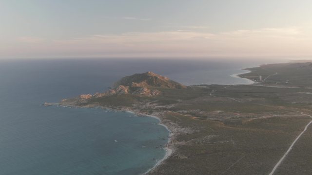 CABO PULMO BCS MEXICO-2022: Coastal Scene with Moving Boat and Rocky Shore