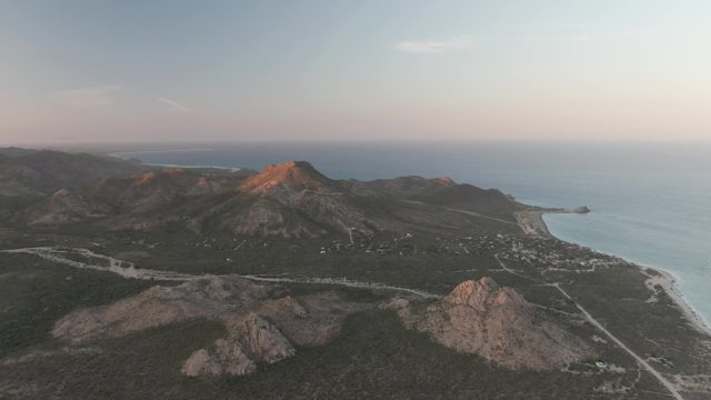 CABO PULMO BCS MEXICO-2022: Vehicle Traveling Along Coastal Mountain Road