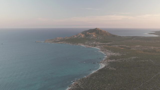 CABO PULMO BCS MEXICO-2022: Boat Moving Near Coastal Hill