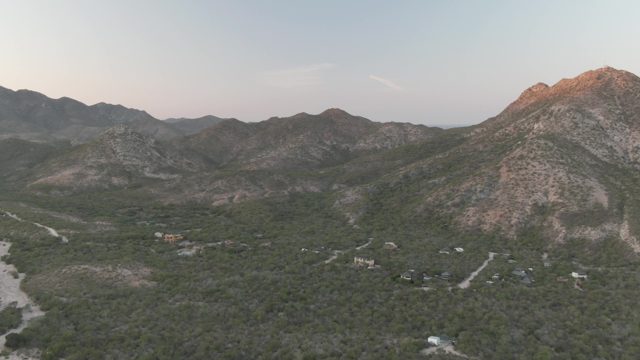 CABO PULMO BCS MEXICO-2022: Mountain Valley with Scattered Buildings and Greenery