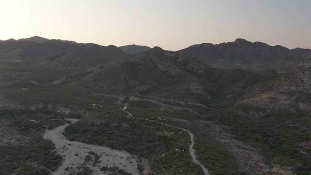 CABO PULMO BCS MEXICO-2022: Mountain Valley Wadi with Moving Vehicles at Dusk
