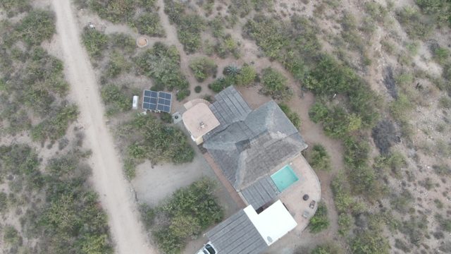 CABO PULMO BCS MEXICO-2022: Car Moving Along Dirt Road near Desert Home