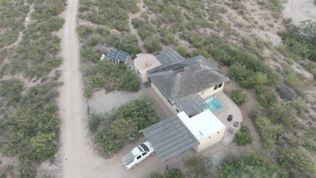 CABO PULMO BCS MEXICO-2022: White SUV Exits House Carport Onto Dirt Road