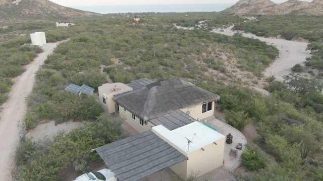 CABO PULMO BCS MEXICO-2022: SUV Driving Away From Desert House Carport